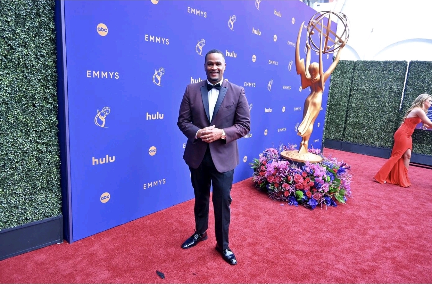 E'Ian West on the Emmys red carpet beside the Hulu and Emmy statue installation