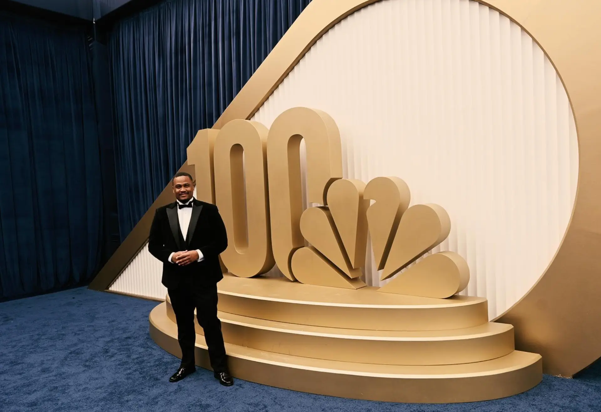 E'Ian West at the Emmys beside the NBC 100 Years installation